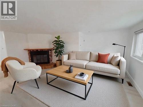 Living room with a brick fireplace - 1949 Old Mill Road, Kitchener, ON - Indoor Photo Showing Living Room With Fireplace