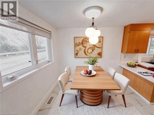 Dining space featuring baseboards and light marble finish floors - 1949 Old Mill Road, Kitchener, ON - Indoor Photo Showing Dining Room