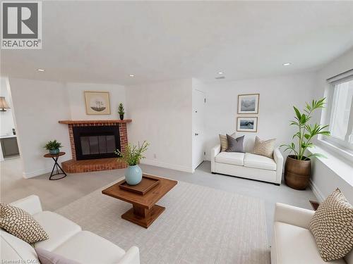 Living room featuring a brick fireplace and recessed lighting - 1949 Old Mill Road, Kitchener, ON - Indoor Photo Showing Living Room With Fireplace