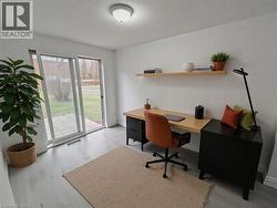 Office space with baseboards and light wood finished floors - 
