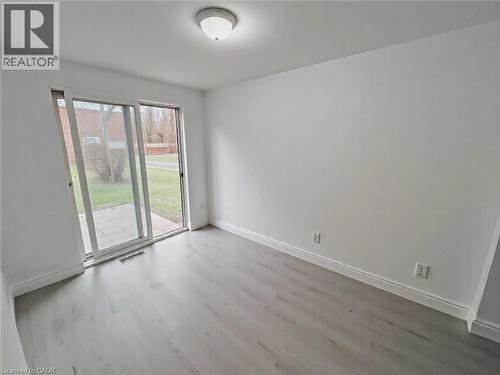 Unfurnished room with wood finished floors and baseboards - 1949 Old Mill Road, Kitchener, ON - Indoor Photo Showing Other Room
