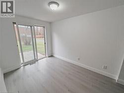 Unfurnished room with wood finished floors and baseboards - 