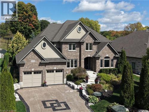 View of front of house with brick siding, concrete driveway, stucco siding, and a garage - 237 River Birch Street, Kitchener, ON - Outdoor With Facade