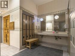 Bathroom featuring tile walls, dark tile patterned flooring, and a sauna - 