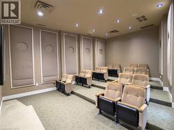 Home theater room with light colored carpet and recessed lighting - 