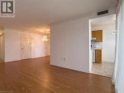 Unfurnished living room with crown molding, light wood-style floors, a chandelier, and a textured ceiling - 