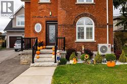 View of front of home with brick siding, driveway, and a front yard - 