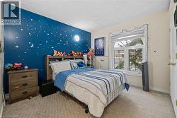 Bedroom with carpet flooring and an accent wall - 