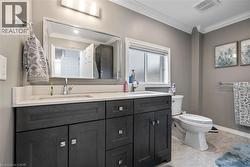Full bathroom with double vanity and crown molding - 