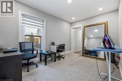 Office with light colored carpet and recessed lighting - 