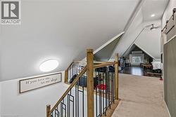 Additional living space featuring a barn door and vaulted ceiling - 