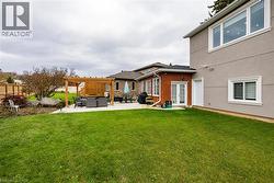 Rear view of house with a patio area, french doors, brick siding, stucco siding, and a pergola - 