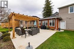 View of patio featuring outdoor lounge area, a pergola, and area for grilling - 