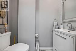 Bathroom with vanity and decorative backsplash - 