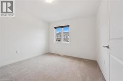 Empty room with light carpet and baseboards - 
