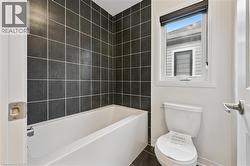 Bathroom with toilet and tile patterned floors - 