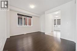 Unfurnished room with dark wood-style floors and baseboards - 