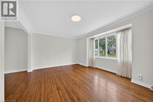 Spare room with wood finished floors and crown molding - 421 East 36Th Street, Hamilton, ON - Indoor Photo Showing Other Room