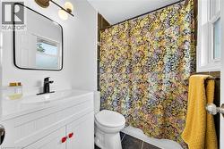 Full bath with vanity, a shower with shower curtain, and tile patterned floors - 