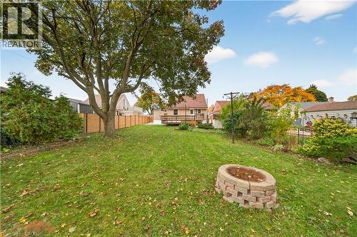 Fenced backyard with an outdoor fire pit and a residential view - 421 East 36Th Street, Hamilton, ON - Outdoor