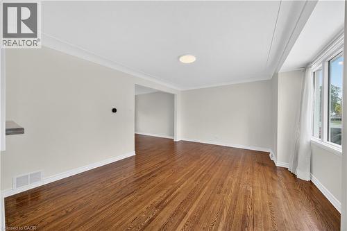 Empty room featuring dark wood-style flooring and baseboards - 421 East 36Th Street, Hamilton, ON - Indoor Photo Showing Other Room
