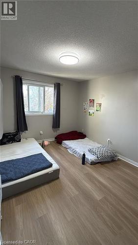 Bedroom with a textured ceiling and wood finished floors - 419 Downsview Place, Waterloo, ON - Indoor Photo Showing Bedroom