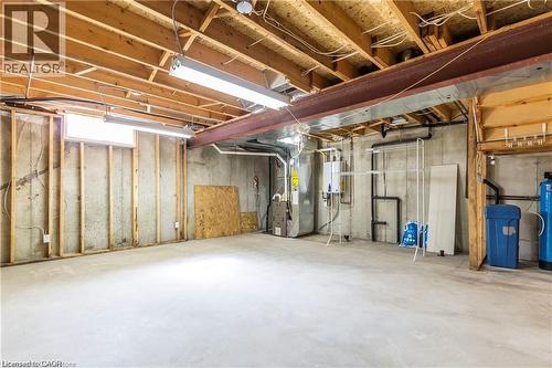 Unfinished basement with heating unit, water heater, and a water softener system - 419 Downsview Place, Waterloo, ON - Indoor Photo Showing Basement