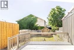 Wooden deck with a shed and a fenced backyard - 