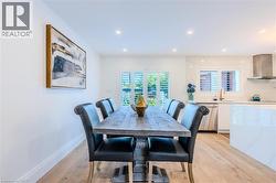 Dining room featuring light wood finished floors and recessed lighting - 