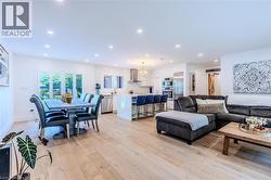 Living room featuring recessed lighting and light wood-style flooring - 