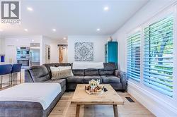 Living area featuring light wood-style floors and recessed lighting - 