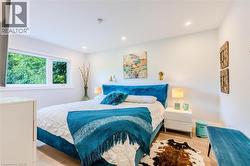 Bedroom with wood finished floors and recessed lighting - 