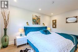 Bedroom with wood finished floors and recessed lighting - 