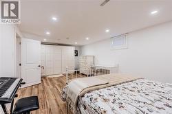 Bedroom featuring light wood-type flooring, recessed lighting, and a closet - 