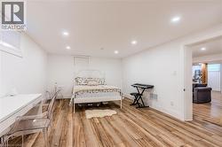 Bedroom with recessed lighting and light wood finished floors - 