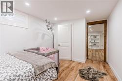 Bedroom with wood-type flooring and recessed lighting - 