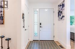 Entrance foyer with baseboards and light floors - 