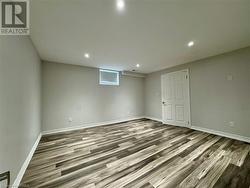 Basement featuring recessed lighting, baseboards, and wood finished floors - 