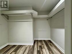 Walk in closet with wood finished floors - 