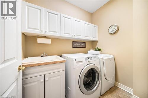 Washroom featuring washer and dryer and cabinet space - 4165 Stonebridge Crescent, Burlington, ON - Indoor Photo Showing Laundry Room
