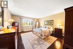 Bedroom with dark wood-type flooring and a textured ceiling - 
