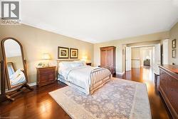 Bedroom featuring dark wood-style flooring and a closet - 