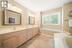 Full bathroom with double vanity and a bathtub - 