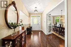 Entryway featuring a chandelier and dark wood finished floors - 