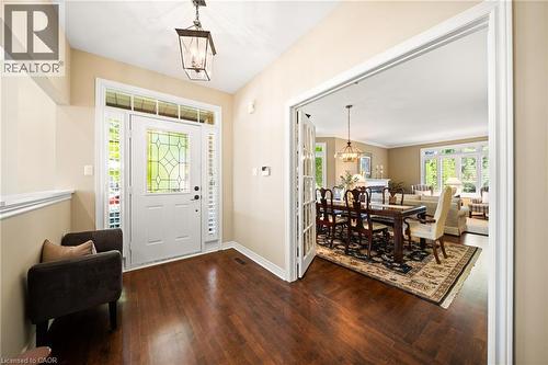 Foyer featuring a chandelier, plenty of natural light, and dark wood-style floors - 4165 Stonebridge Crescent, Burlington, ON - Indoor