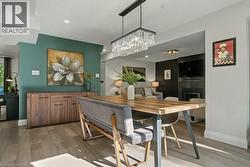 Dining area featuring light wood finished floors, an accent wall, and recessed lighting - 