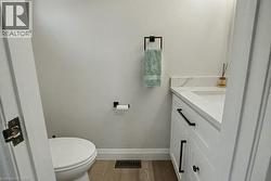 Half bath featuring vanity and light wood finished floors - 