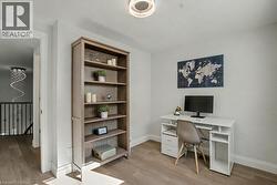 Office space with light wood-style floors and baseboards - 