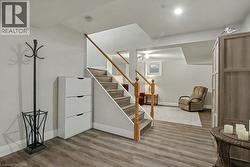 Finished below grade area featuring light wood-type flooring and stairs - 