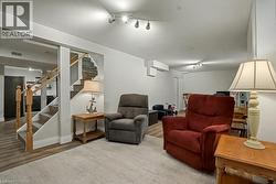 Living area featuring wood finished floors and stairs - 